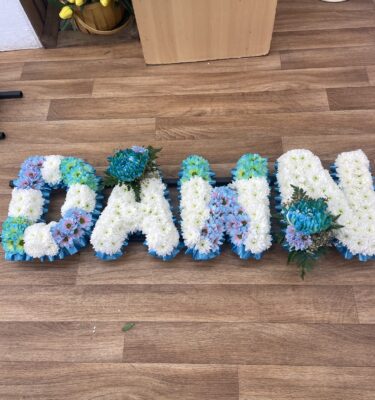 “Patchwork Style Funeral Tribute Letters, intricately designed with vibrant colours and floral arrangements, symbolizing love and remembrance for a cherished memory.”
