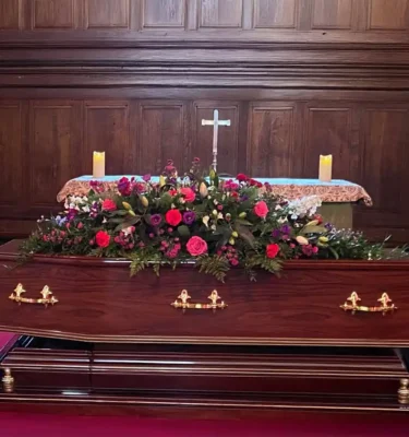 Bright colourful coffin spray. Sunflorist & Events Florists London
