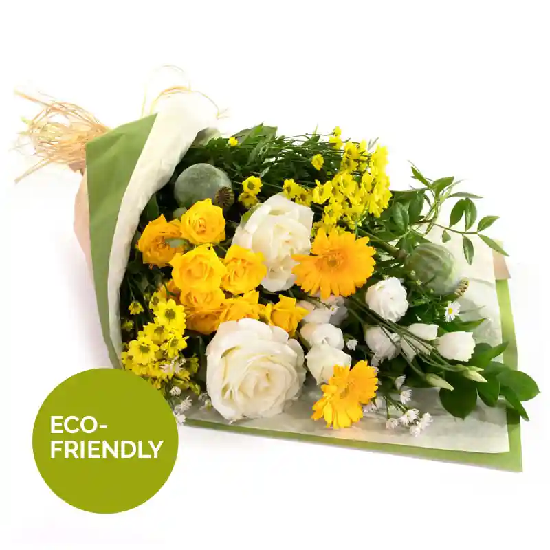 A bouquet of fresh yellow and white flowers, including roses, daisies, and greenery, wrapped in eco-friendly packaging with natural raffia ties. The bouquet has a bright and cheerful appearance, with a mix of delicate blooms and lush foliage.