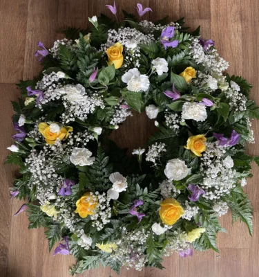 Honour your loved one with a beautiful Campanula and Yellow Rose Funeral Wreath. This stunning floral arrangement combines the delicate charm of Campanula flowers with the warm warmth of yellow roses, creating a heartfelt tribute to celebrate life and memories. Perfect for expressing sympathy and love during difficult times, this elegant floral wreath is a meaningful gesture of remembrance. Discover how flowers can convey your deepest condolences with this exquisite funeral wreath.