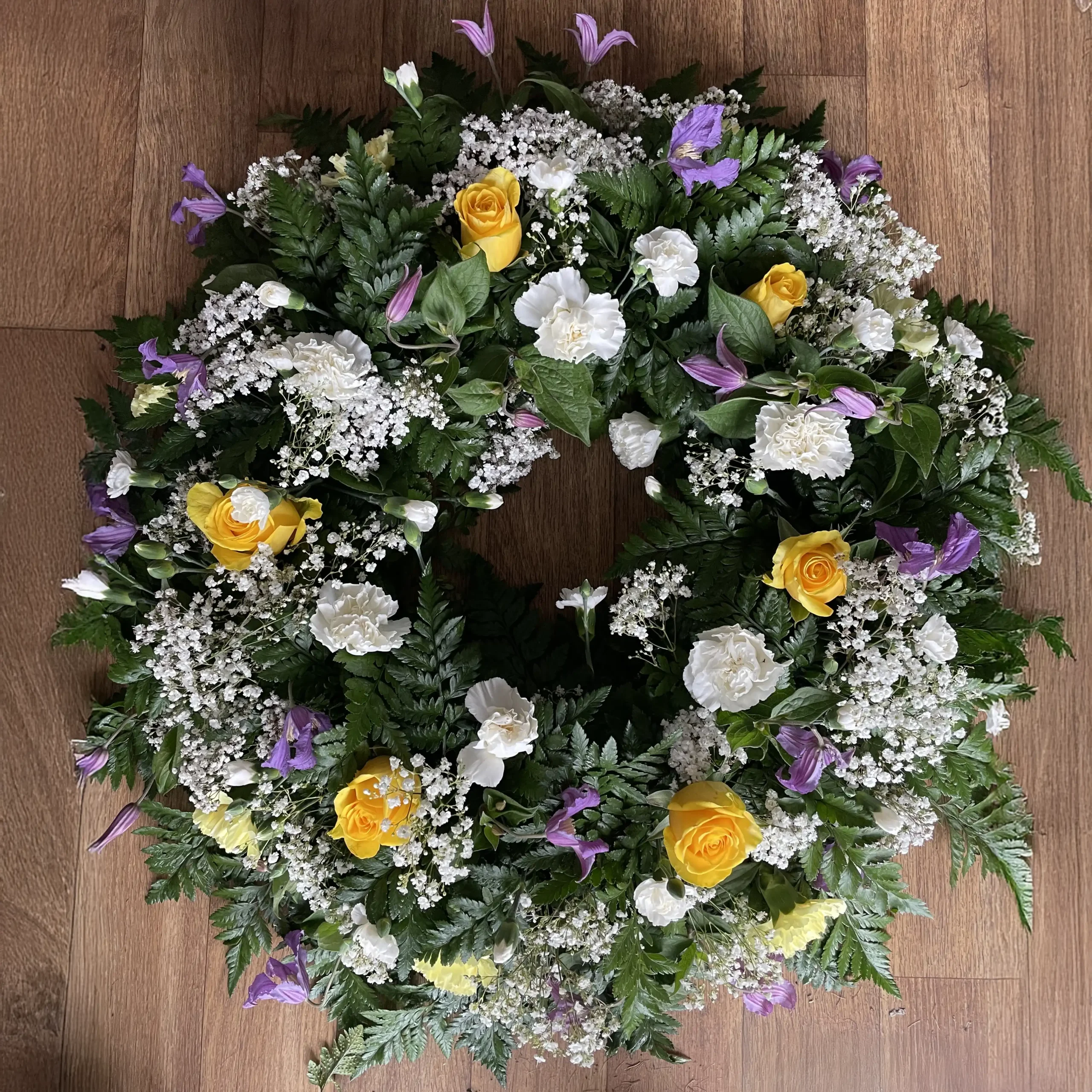 Honour your loved one with a beautiful Campanula and Yellow Rose Funeral Wreath. This stunning floral arrangement combines the delicate charm of Campanula flowers with the warm warmth of yellow roses, creating a heartfelt tribute to celebrate life and memories. Perfect for expressing sympathy and love during difficult times, this elegant floral wreath is a meaningful gesture of remembrance. Discover how flowers can convey your deepest condolences with this exquisite funeral wreath.